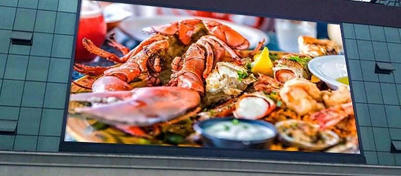 Large outdoor LED screen set into a building frontage