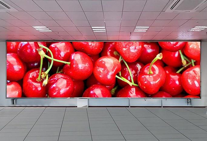 Wide LED feature wall of cherries in a lobby