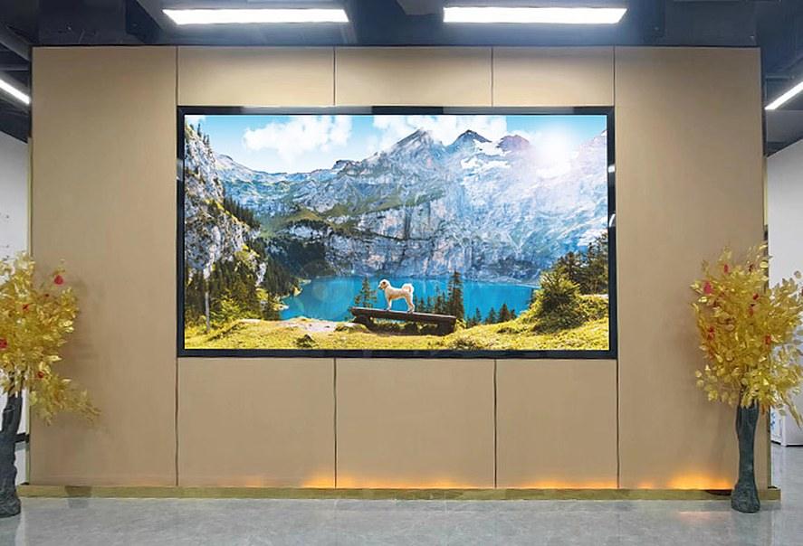 Framed LED feature wall showing a mountain lake, set into a panelled wall with a polished floor