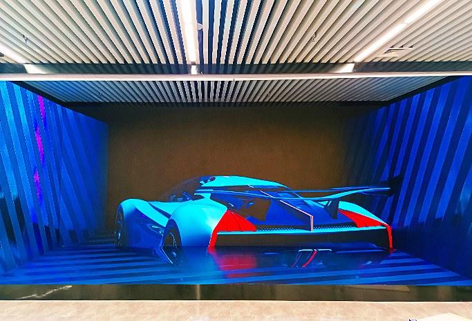Immersive LED showroom with a concept car on wrap-around walls